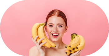 the girl is holding bananas